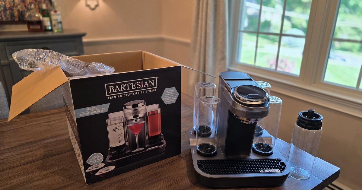 Bartesian Premier machine beside its retail box, set up with glass spirit bottles